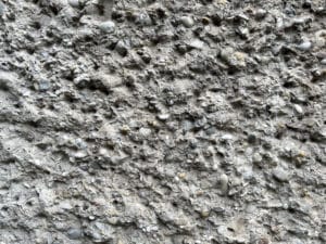 Close-up texture of a pebble-dashed wall.