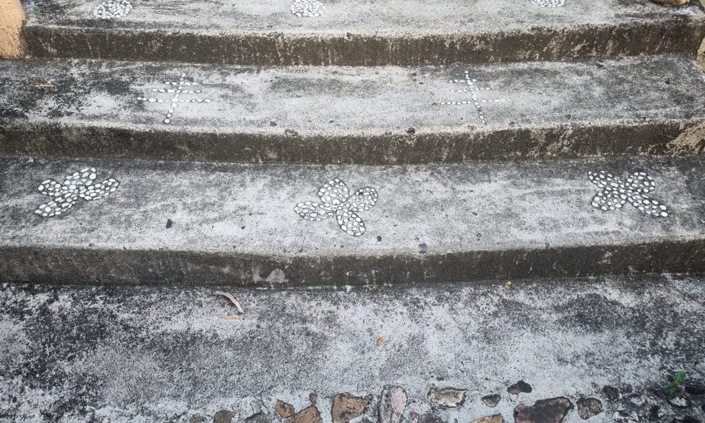 Concrete steps with tactile paving indicators.