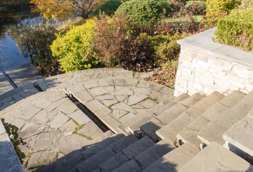 Stone staircase in sunny autumn garden.