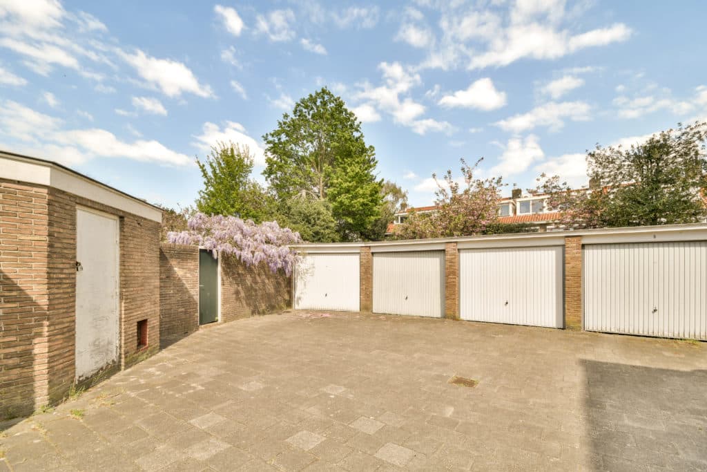 Residential garage area with blooming wisteria and blue sky