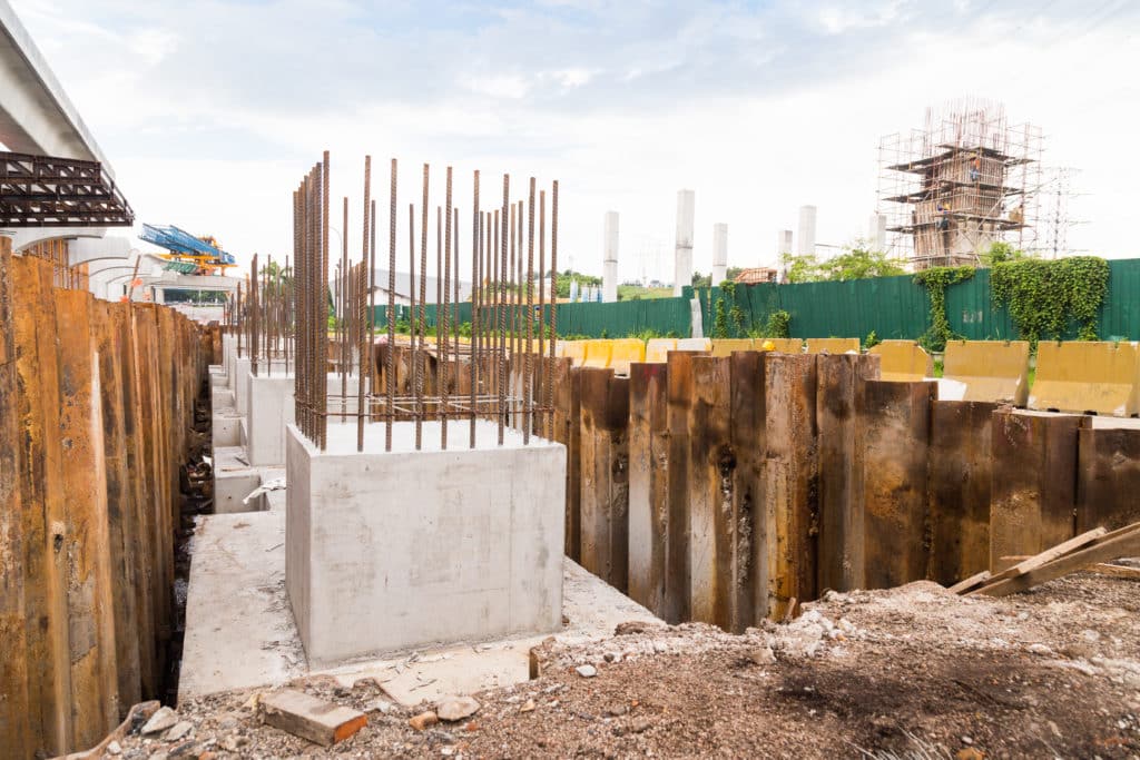 Construction site foundation with steel rebar and formwork.