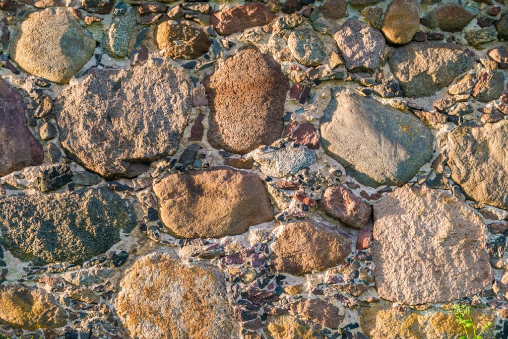 Textured stone wall in sunlight.