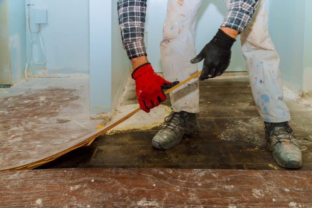 Worker measuring for floor installation.