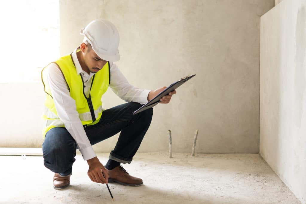 Construction inspector examining building interior.