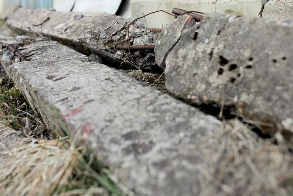 Damaged concrete slabs with exposed rebar.