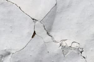 Close-up of cracked white wall texture.