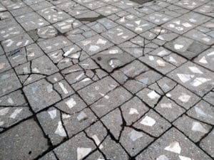 Mosaic stone pavement texture with geometric shapes.