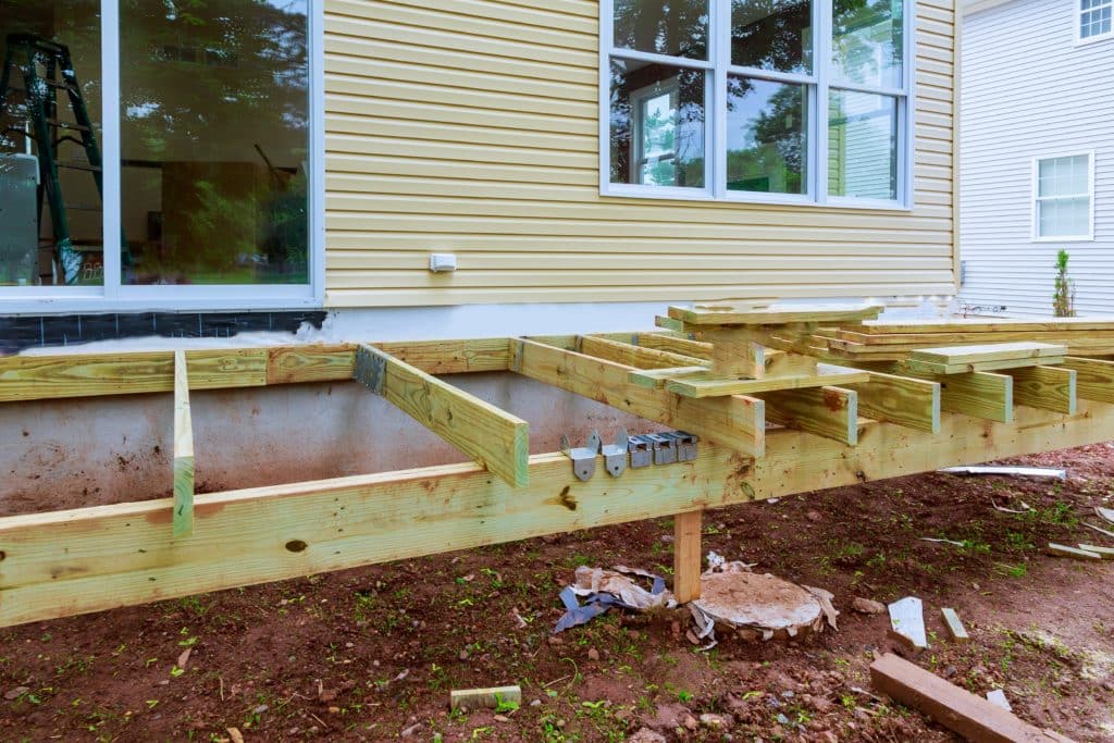 Wooden deck construction at residential home.