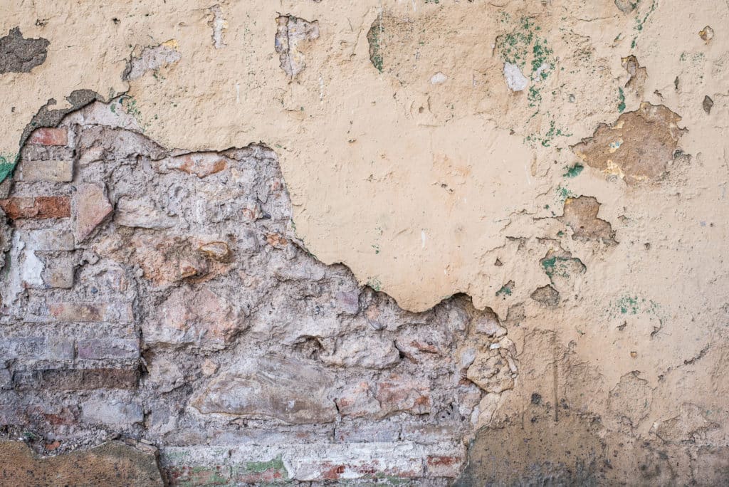 Peeling paint on old brick wall texture.