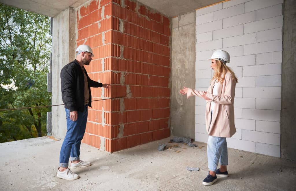 Engineers discussing construction site indoors