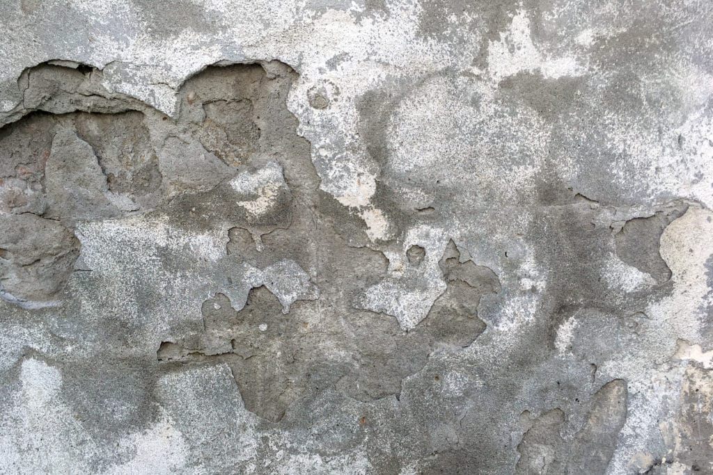 Cracked weathered concrete wall texture.