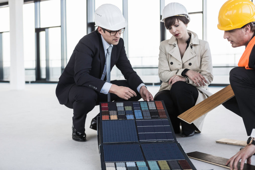 Architects discussing material samples in office