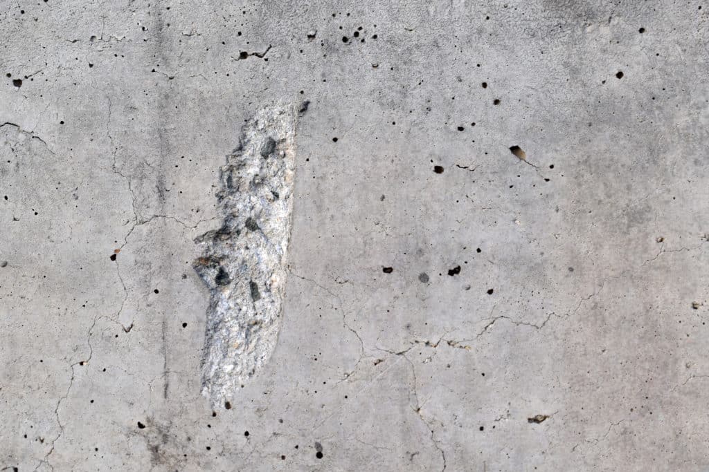 Close-up of textured concrete surface with crack.