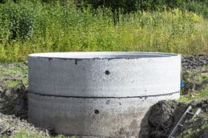Concrete well ring in a field.