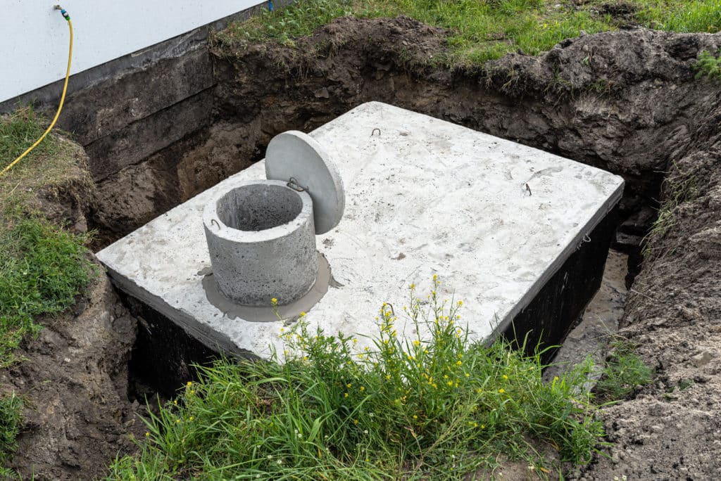 Concrete septic tank installation in progress.