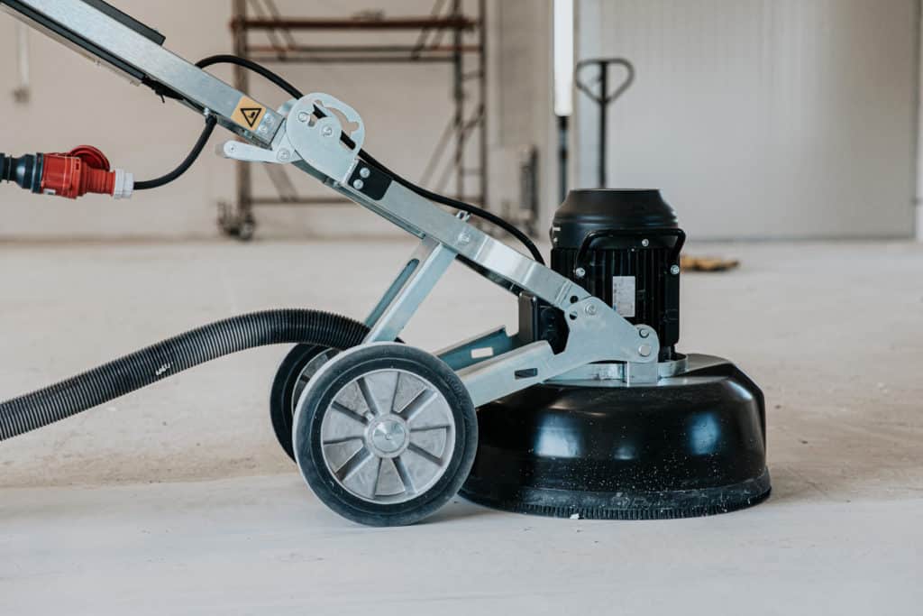 Industrial floor cleaning machine on concrete surface.