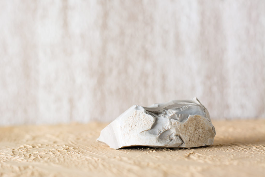 Crushed paper bag on wooden surface.