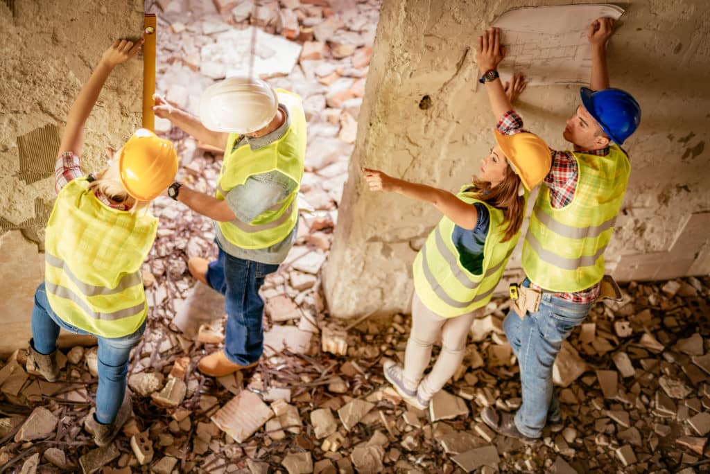 Construction workers assessing building renovation.CASCADE-12345