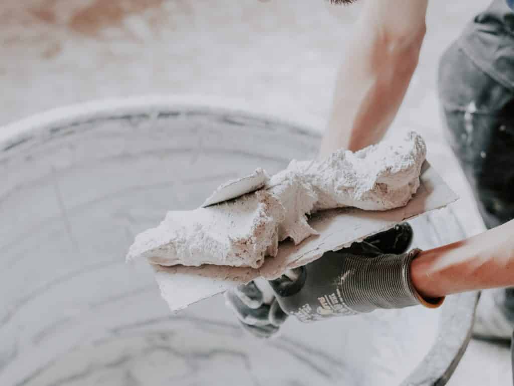 Worker carrying plaster on a trowel