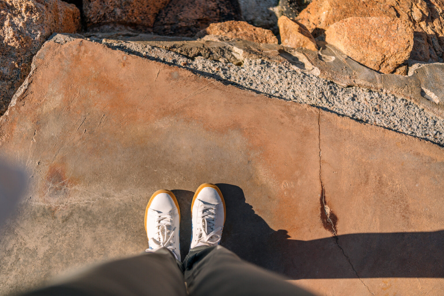 Close-up shot of shoes on rocky ground