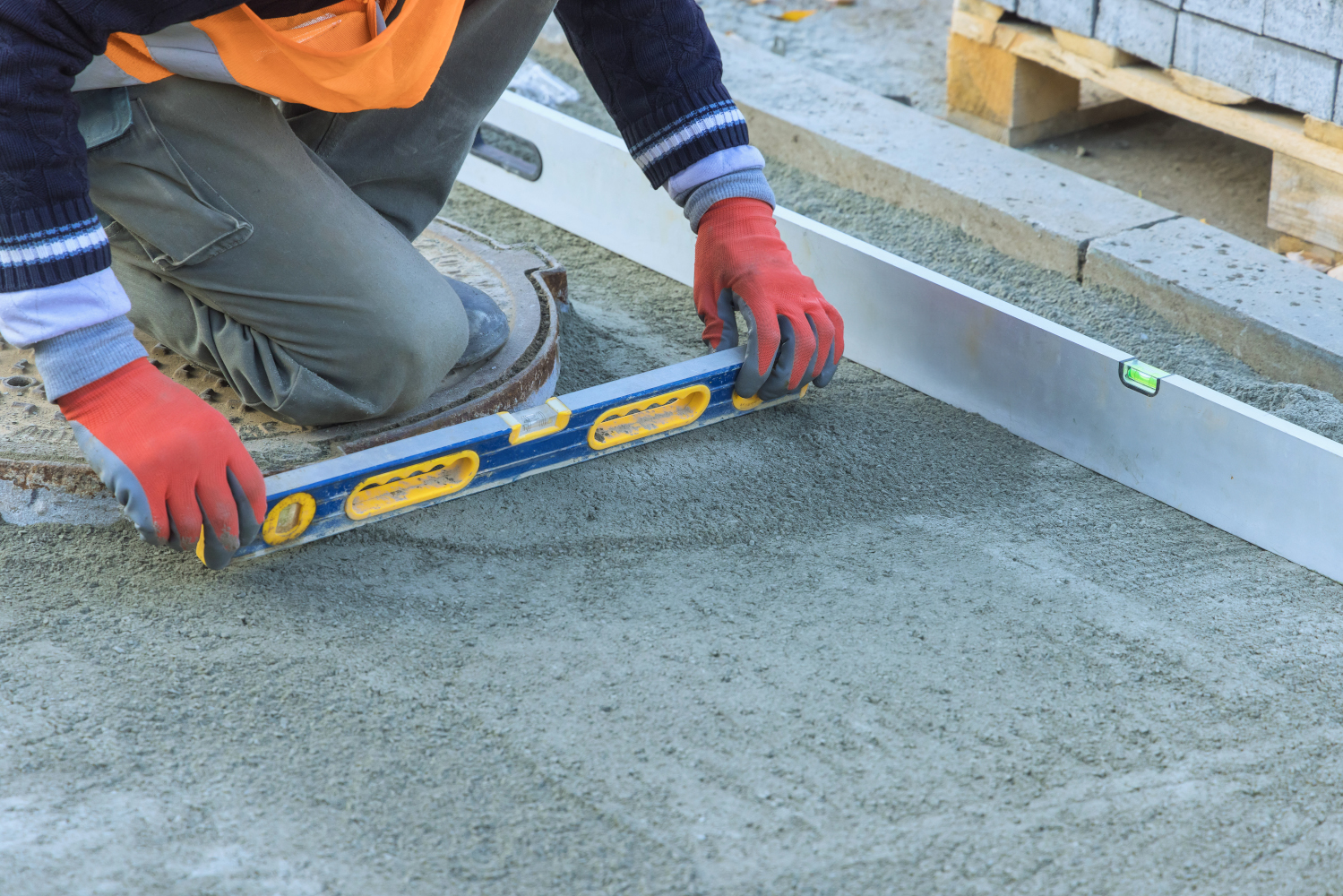 Illustration of a construction worker using foam concrete leveling equipment to repair a sunken concrete slab, showcasing the process and benefits of foam concrete leveling in 2025.